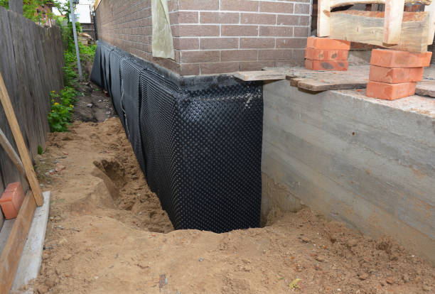 Happy homeowners after waterproofing job in Fredonia